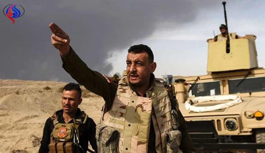 رفع العلم العراقي على حي الاندلس ومبانيه بالموصل