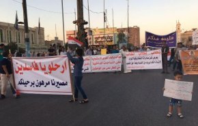 المئات يتظاهرون وسط النجف ويحملون لافتات 